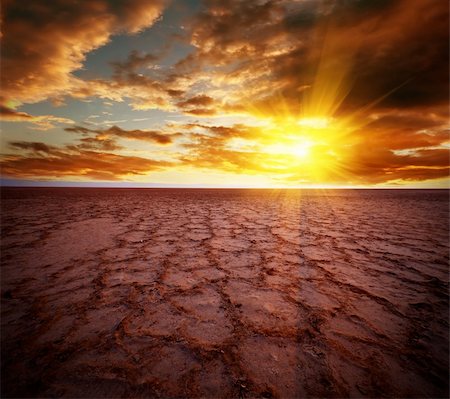 dawn red sky - Beautiful dramatic sunrise over great dried-up salt lake Chott el Djerid in Tunisia Stock Photo - Budget Royalty-Free & Subscription, Code: 400-05734038