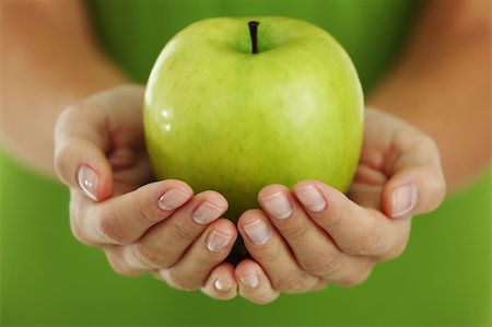 green apple in woman hands Stock Photo - Budget Royalty-Free & Subscription, Code: 400-05734218