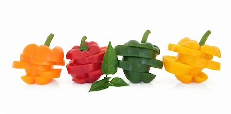 simsearch:400-06061963,k - Orange, red, green and yellow sliced pepper vegetables in layered stacks with leaf sprig isolated over white background. Foto de stock - Royalty-Free Super Valor e Assinatura, Número: 400-05734303