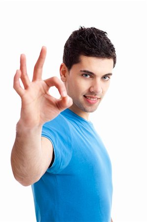simsearch:400-06769983,k - Portrait of a smiling handsome young man gesturing ok sign over a  white background Foto de stock - Royalty-Free Super Valor e Assinatura, Número: 400-05734431