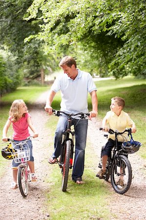 simsearch:400-04402100,k - Father and children riding bikes in countryside Stock Photo - Budget Royalty-Free & Subscription, Code: 400-05735161