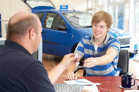 Young man filling in paperwork in car showroom Stock Photo - Budget Royalty-Free & Subscription, Code: 400-05735234