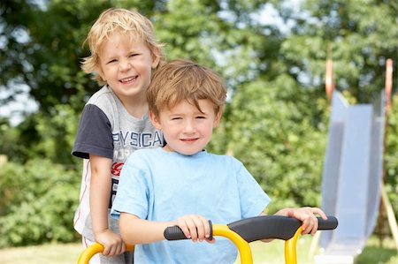 pictures of kids and friends playing at school - Two Young Boys Playing on Bike Stock Photo - Budget Royalty-Free & Subscription, Code: 400-05735255