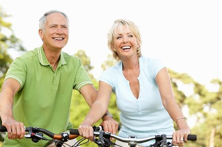 simsearch:400-05735475,k - Mature couple riding bikes Stock Photo - Budget Royalty-Free & Subscription, Code: 400-05735480