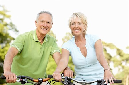 simsearch:400-05735475,k - Mature couple riding bikes Stock Photo - Budget Royalty-Free & Subscription, Code: 400-05735481