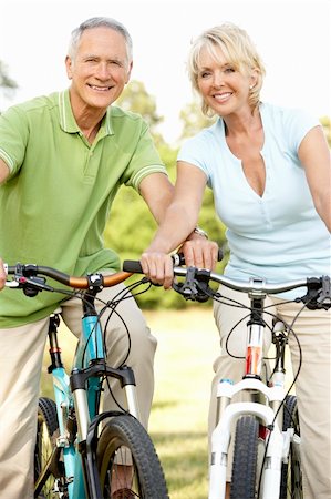 simsearch:400-05735475,k - Mature couple riding bikes Stock Photo - Budget Royalty-Free & Subscription, Code: 400-05735482