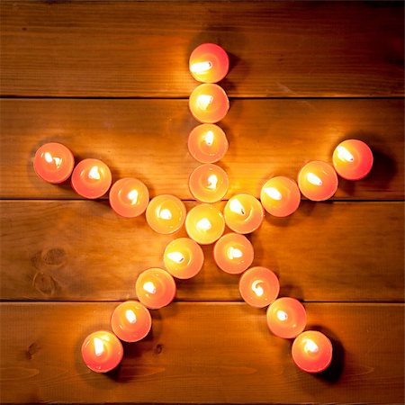 family relaxing at christmas - christmas candles pentagram star on golden warm wood Stock Photo - Budget Royalty-Free & Subscription, Code: 400-05735984