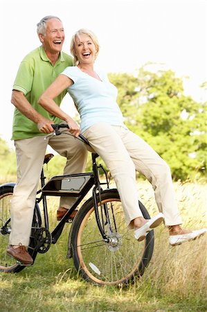 simsearch:400-05735475,k - Mature couple riding bike in countryside Stock Photo - Budget Royalty-Free & Subscription, Code: 400-05736035