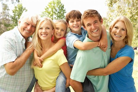 simsearch:400-06097548,k - Mother And Father Giving Children Piggy Back With Grandparents Photographie de stock - Aubaine LD & Abonnement, Code: 400-05736138