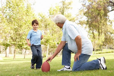 Grandfather And Grandson Playing American Football Together Stock Photo - Budget Royalty-Free & Subscription, Code: 400-05736196