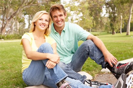 Couple Putting On In Line Skates In Park Stock Photo - Budget Royalty-Free & Subscription, Code: 400-05736206