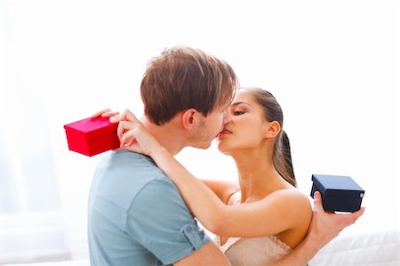 Young couple kissing after exchanging presents Stock Photo - Budget Royalty-Free & Subscription, Code: 400-05736280