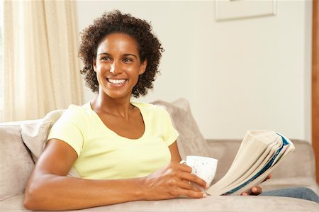 Woman Reading Book With Drink At Home Stockbilder - Microstock & Abonnement, Bildnummer: 400-05736319