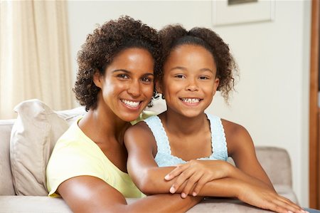 Mother And Daughter Relaxing On Sofa At Home Stock Photo - Budget Royalty-Free & Subscription, Code: 400-05736326