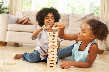 Brother And Sister Playing Game At Home Stock Photo - Budget Royalty-Free & Subscription, Code: 400-05736360