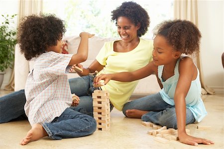 Brother And Sister Playing Game With Mother At Home Stock Photo - Budget Royalty-Free & Subscription, Code: 400-05736361