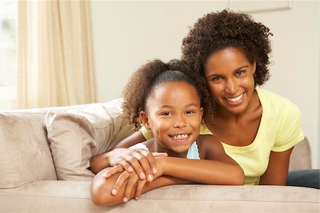 Mother And Daughter Relaxing On Sofa At Home Stock Photo - Budget Royalty-Free & Subscription, Code: 400-05736385