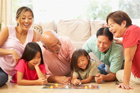 simsearch:400-06098367,k - Extended Family Group Playing Board Game At Home Stock Photo - Budget Royalty-Free & Subscription, Code: 400-05736507