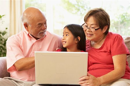 Grandparents And Granddaughter Using Laptop Computer At Home Stock Photo - Budget Royalty-Free & Subscription, Code: 400-05736500
