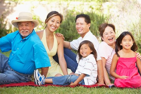 simsearch:400-06098367,k - Extended Family Group Relaxing In Garden Stock Photo - Budget Royalty-Free & Subscription, Code: 400-05736561