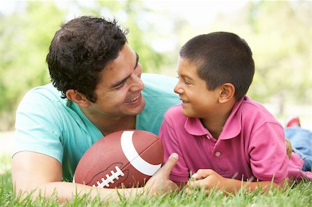 simsearch:400-05736759,k - Father And Son In Park With American Football Stock Photo - Budget Royalty-Free & Subscription, Code: 400-05736794