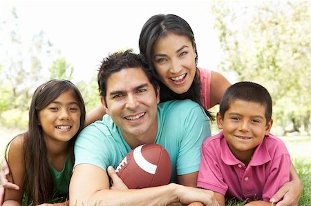 father and daughter playing football - Family In Park With American Football Stock Photo - Budget Royalty-Free & Subscription, Code: 400-05736800