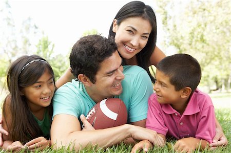 father and daughter playing football - Family In Park With American Football Stock Photo - Budget Royalty-Free & Subscription, Code: 400-05736801