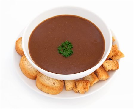 queue de boeuf - Oxtail soup with parsley herb and toasted croutons in a porcelain bowl with plate over white background. Photographie de stock - Aubaine LD & Abonnement, Code: 400-05736859