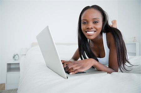 simsearch:400-05737165,k - Woman chatting with her laptop in her bedroom Stock Photo - Budget Royalty-Free & Subscription, Code: 400-05737221