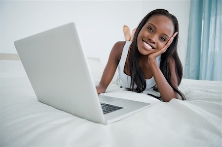 simsearch:400-05737165,k - Woman watching a movie on her notebook in her bedroom Stock Photo - Budget Royalty-Free & Subscription, Code: 400-05737223