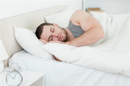 simsearch:400-05729351,k - Serene man sleeping in his bedroom Photographie de stock - Aubaine LD & Abonnement, Code: 400-05737246