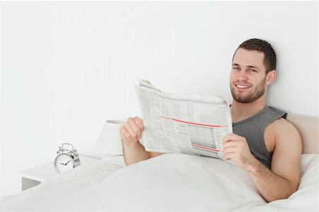 Quiet man reading a newspaper in his bedroom Stock Photo - Budget Royalty-Free & Subscription, Code: 400-05737377