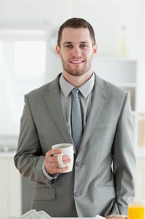 simsearch:400-05737647,k - Portrait of a businessman having breakfast in his kitchen Stock Photo - Budget Royalty-Free & Subscription, Code: 400-05737609
