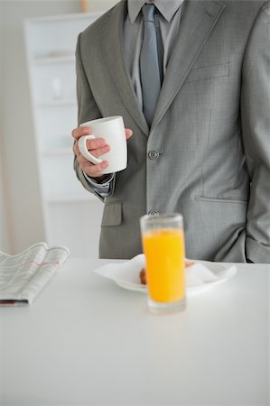 Portrait of a breakfast taken by a businessman in his kitchen Stock Photo - Budget Royalty-Free & Subscription, Code: 400-05737614