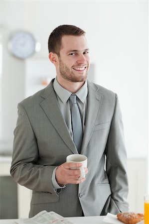 simsearch:400-04335708,k - Portrait of a smiling businessman having breakfast in his breakfast Stockbilder - Microstock & Abonnement, Bildnummer: 400-05737611