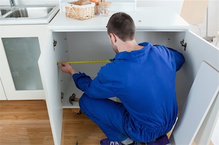 simsearch:400-08054637,k - Repair man measuring something in a kitchen Stock Photo - Budget Royalty-Free & Subscription, Code: 400-05737659