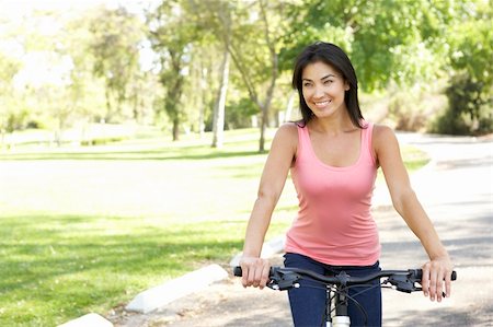 simsearch:400-04402106,k - Young Woman Riding Bike In Park Fotografie stock - Microstock e Abbonamento, Codice: 400-05737828