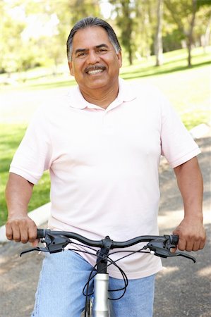 simsearch:400-04402100,k - Senior Man Riding Bike In Park Stock Photo - Budget Royalty-Free & Subscription, Code: 400-05737821