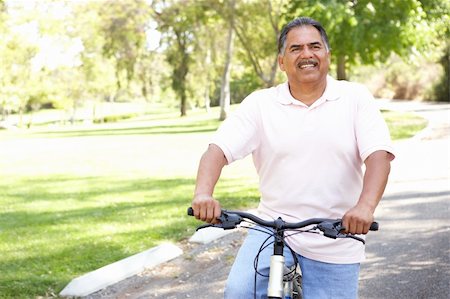 simsearch:400-04402100,k - Senior Man Riding Bike In Park Stock Photo - Budget Royalty-Free & Subscription, Code: 400-05737822