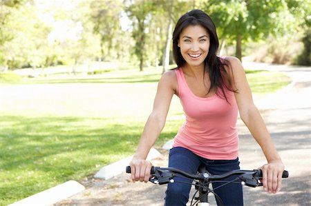 simsearch:400-04402100,k - Young Woman Riding Bike In Park Stock Photo - Budget Royalty-Free & Subscription, Code: 400-05737830