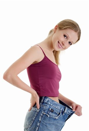 fat belly white background - pretty girl in jeans lost weight on a white background Stock Photo - Budget Royalty-Free & Subscription, Code: 400-05739230