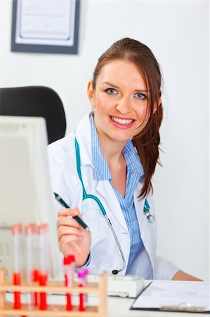 simsearch:400-04925813,k - Portrait of smiling female medical doctor at office Stock Photo - Budget Royalty-Free & Subscription, Code: 400-05739352