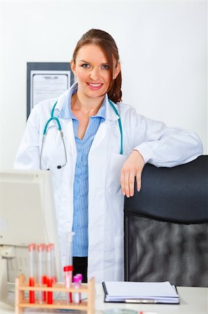 simsearch:400-07099889,k - Portrait of female medical doctor standing at office desk Stock Photo - Budget Royalty-Free & Subscription, Code: 400-05739372