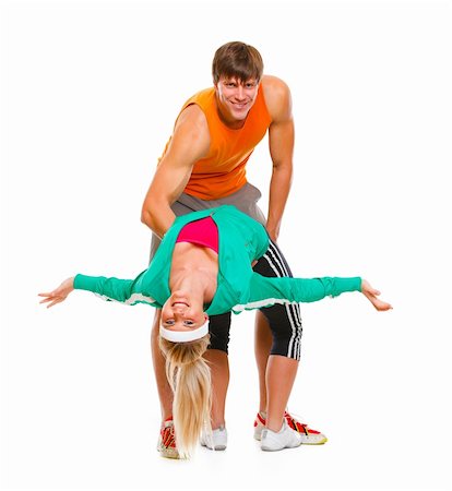 funny wellness healthcare - Fit young female and guy in sportswear having fun isolated on white Stock Photo - Budget Royalty-Free & Subscription, Code: 400-05739399