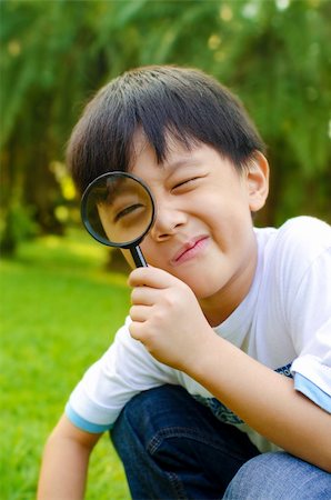 Little boy exploring nature by magnifier Stock Photo - Budget Royalty-Free & Subscription, Code: 400-05739739