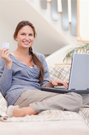 Portrait of a happy woman shopping online in her living room Stock Photo - Budget Royalty-Free & Subscription, Code: 400-05739918