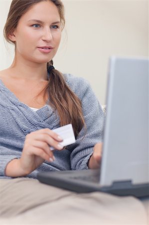 Portrait of a woman booking her holidays online in her living room Stock Photo - Budget Royalty-Free & Subscription, Code: 400-05739920