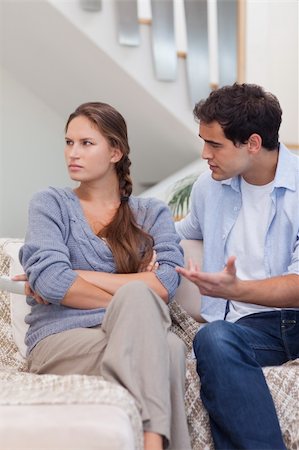 Portrait of a woman being mad at her boyfriend in their living room Stock Photo - Budget Royalty-Free & Subscription, Code: 400-05739938