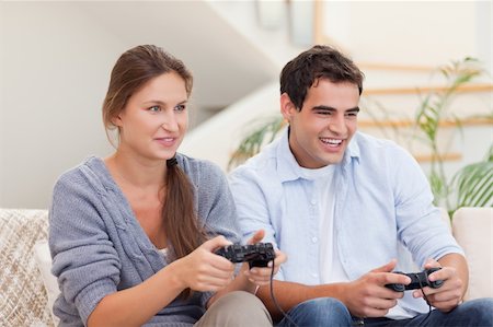 simsearch:400-05297936,k - Young couple playing video games in their living room Stock Photo - Budget Royalty-Free & Subscription, Code: 400-05739968