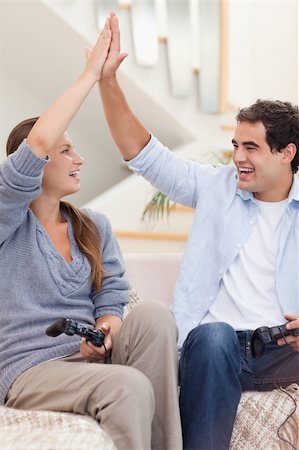 simsearch:400-05297936,k - Portrait of a cheerful couple playing video games in their living room Stock Photo - Budget Royalty-Free & Subscription, Code: 400-05739969